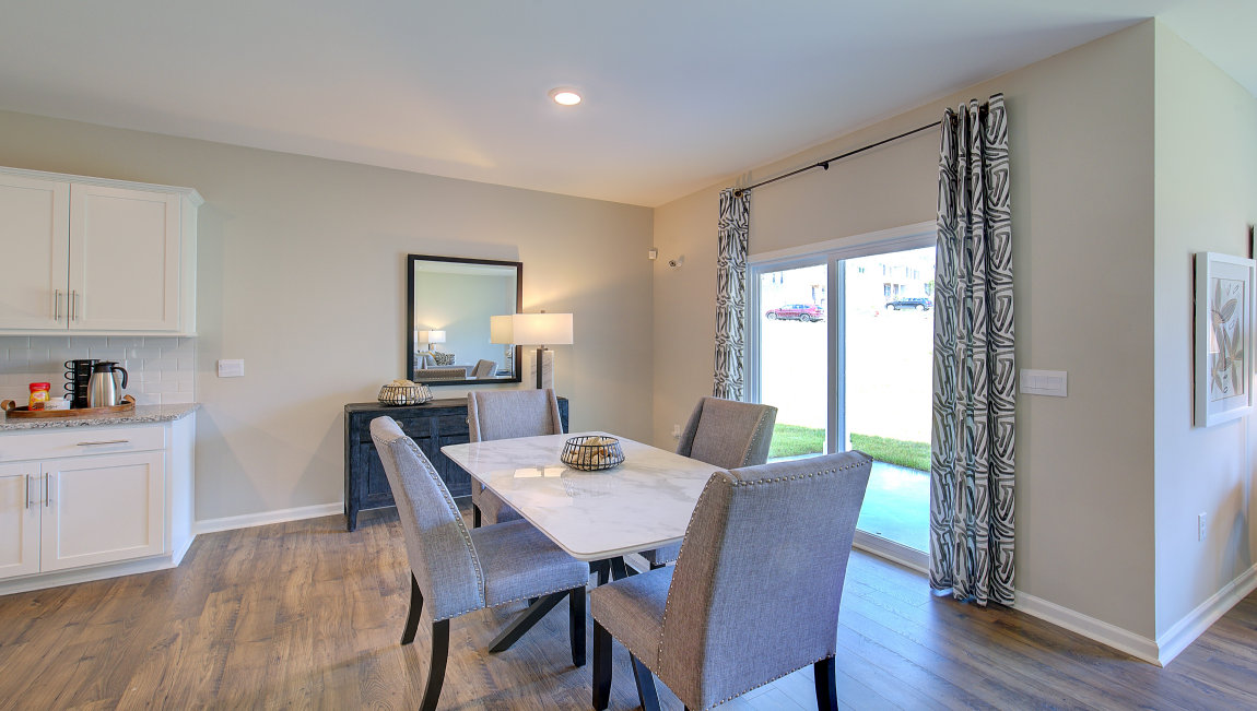 Dining area with wood floors and sliding glass back door