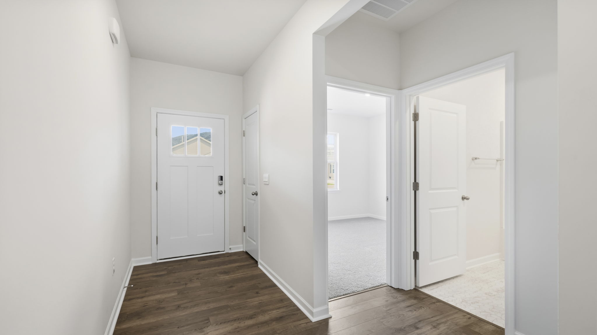 Welcome foyer with view of the front bedroom and bathroom
