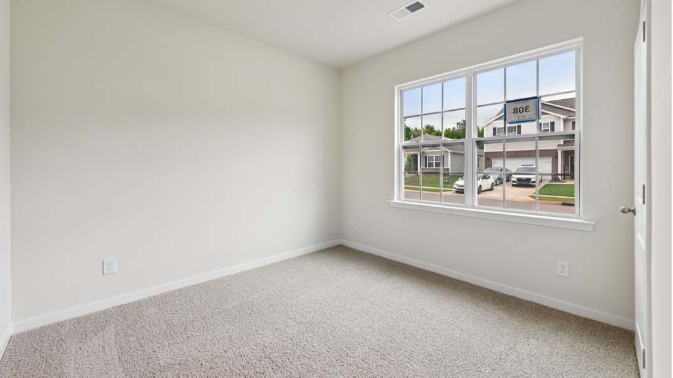 Carpeted bedroom with large window