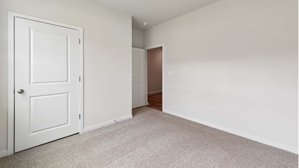 Carpeted bedroom with large window