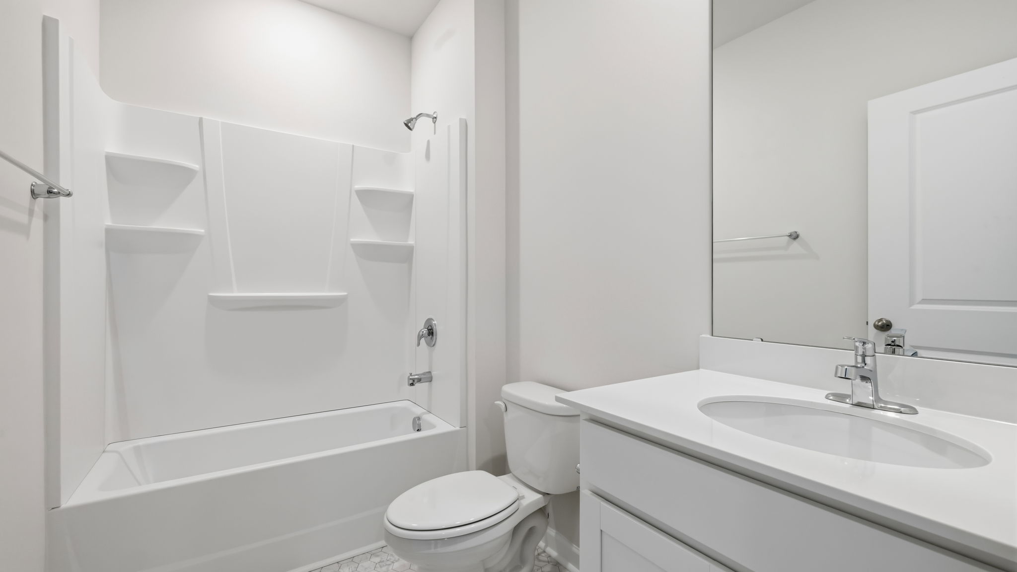 Bathroom with white countertops and bathtub