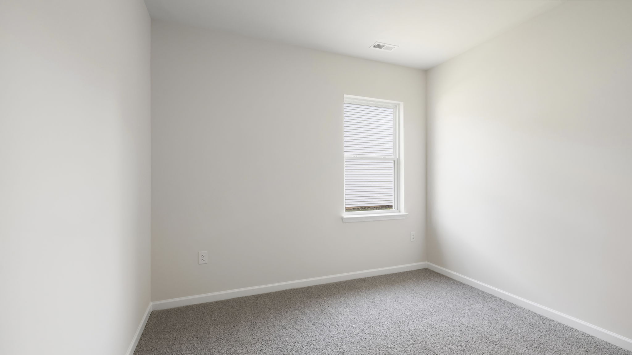 Carpeted bedroom with large window