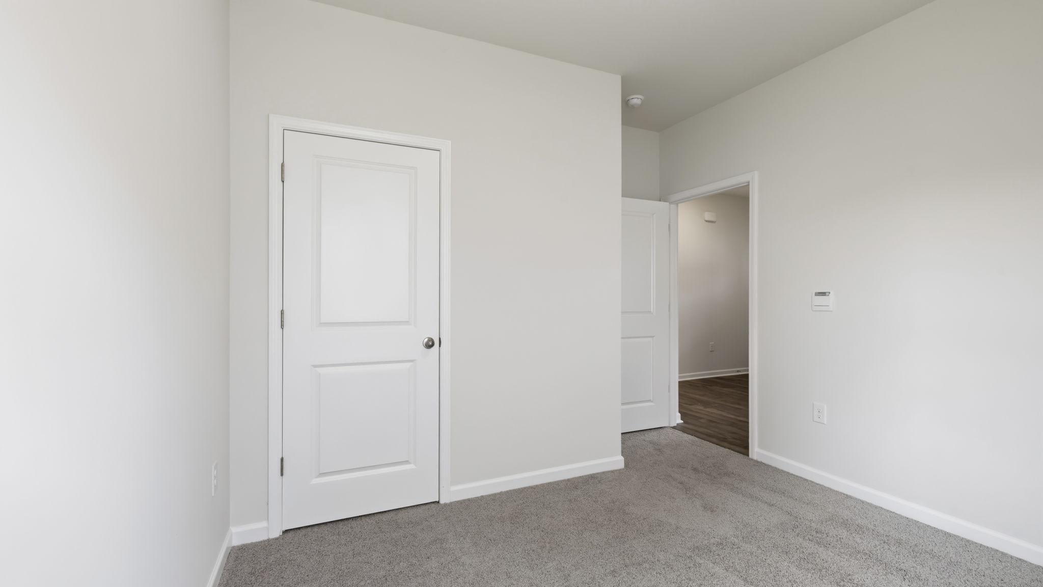 Carpeted bedroom with large window