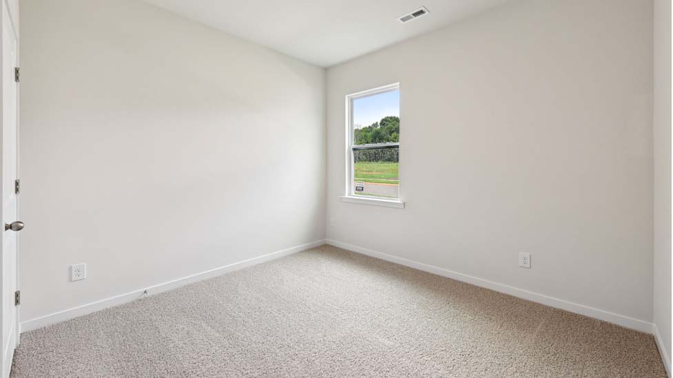 Carpeted bedroom with large window