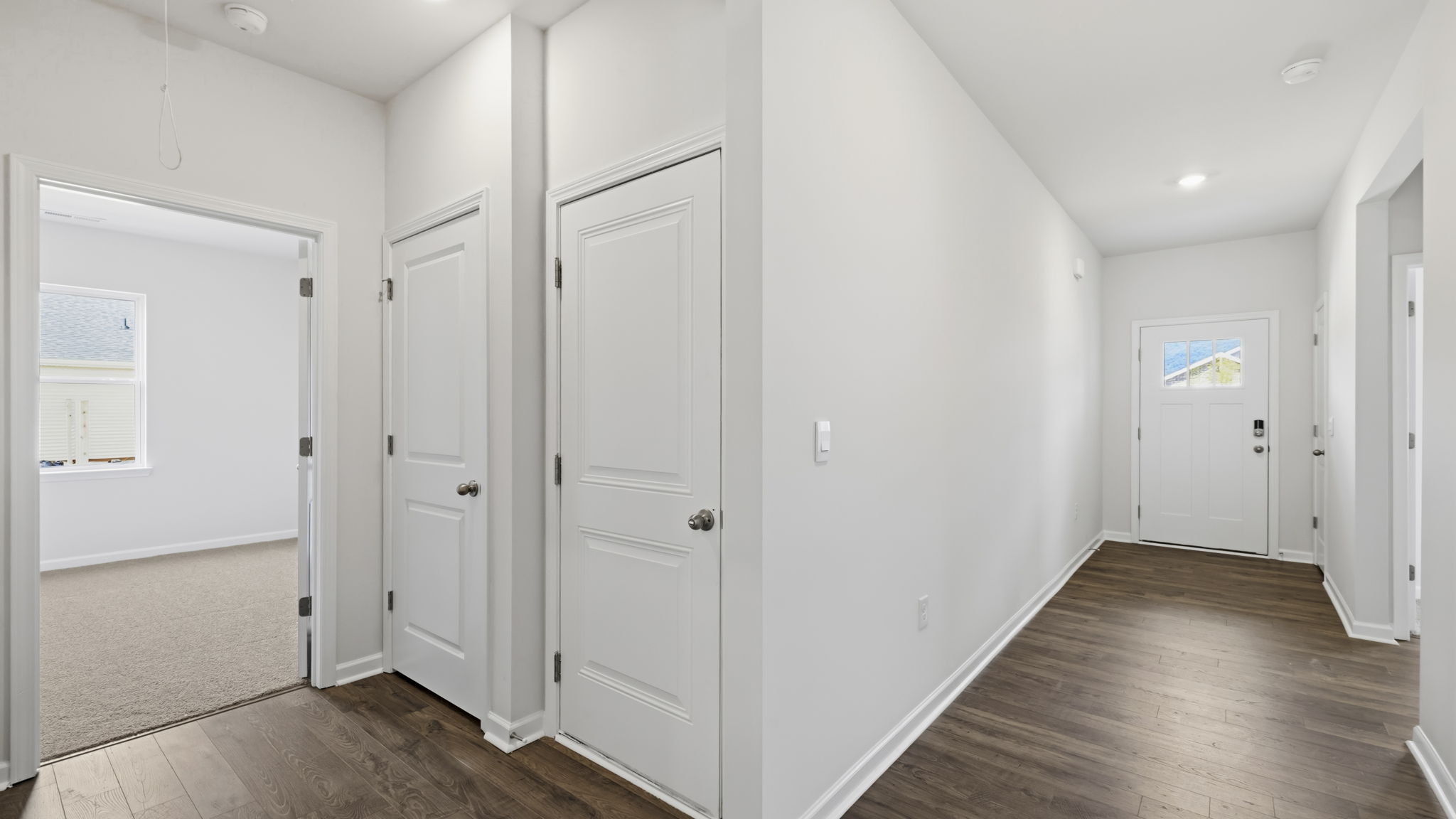 Hallway with view of multiple rooms