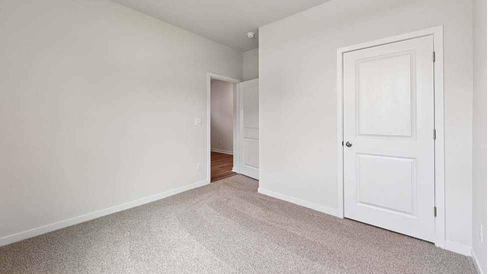 Carpeted bedroom with large window