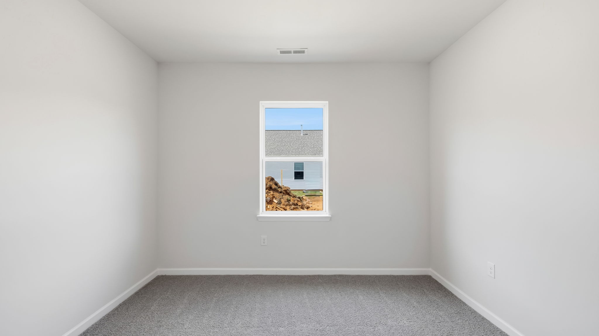 Carpeted bedroom with large window