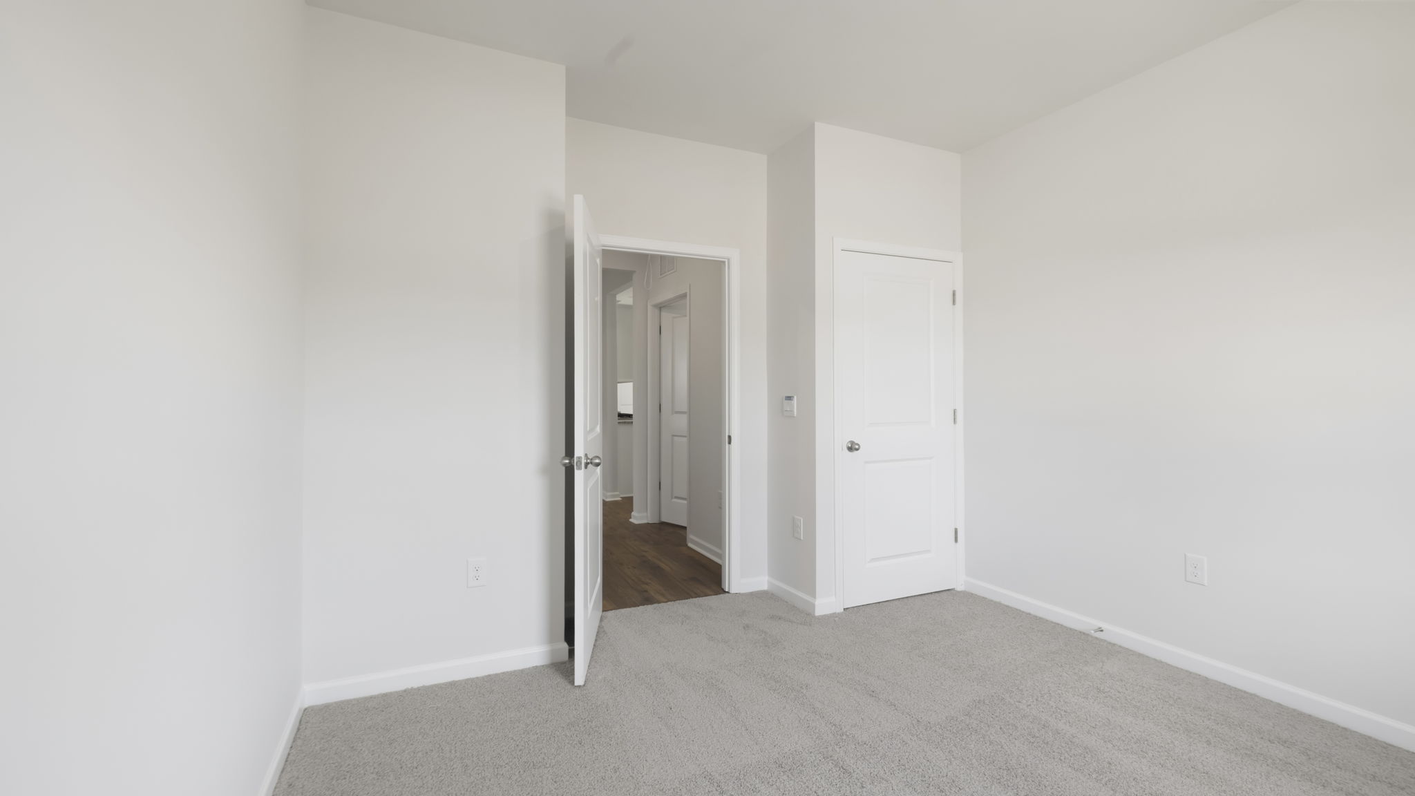 Carpeted bedroom with large window
