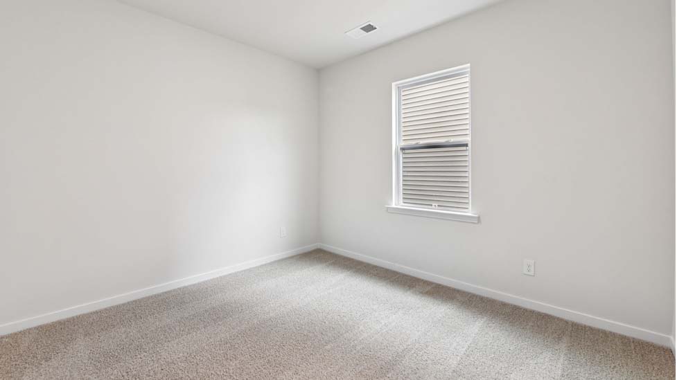 Carpeted bedroom with large window