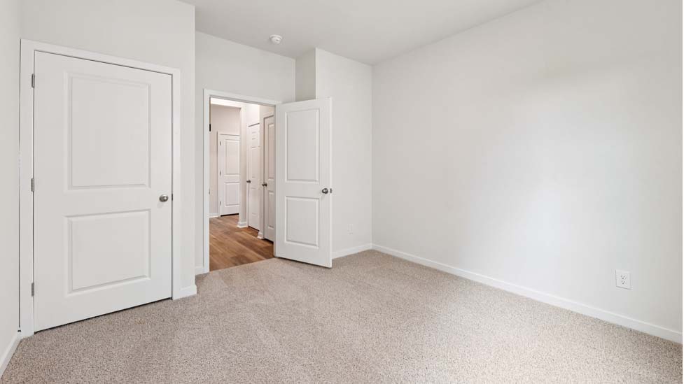 Carpeted bedroom with large window