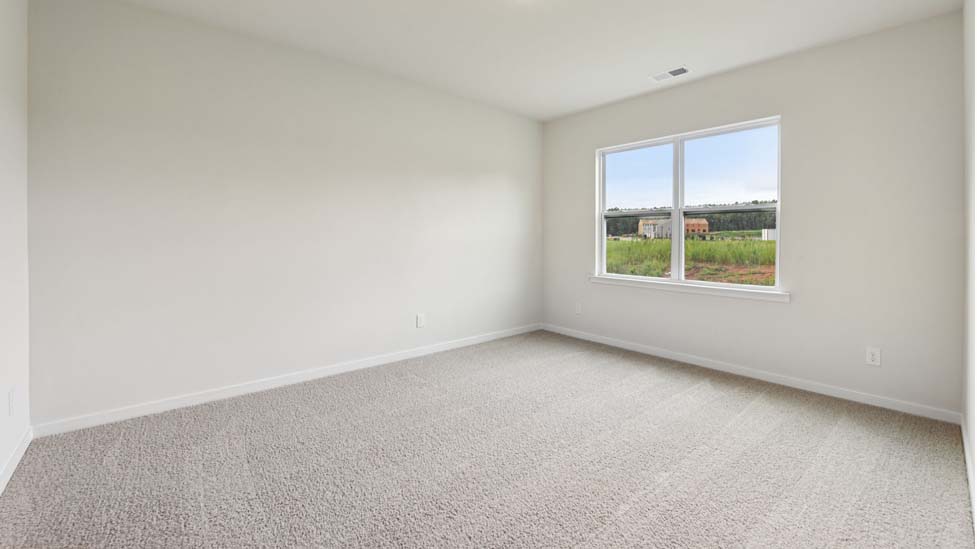 Carpeted bedroom with large window