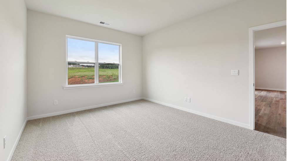Carpeted bedroom with large window