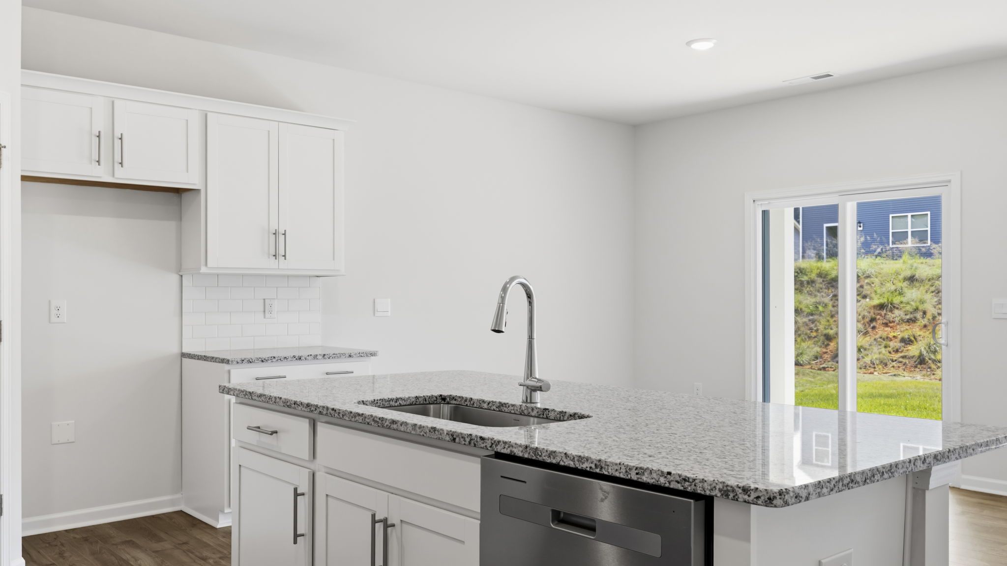 Open concept kitchen with large island and sliding glass doors