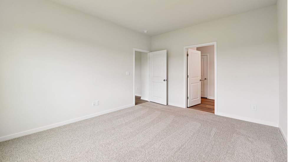 Carpeted bedroom with large window
