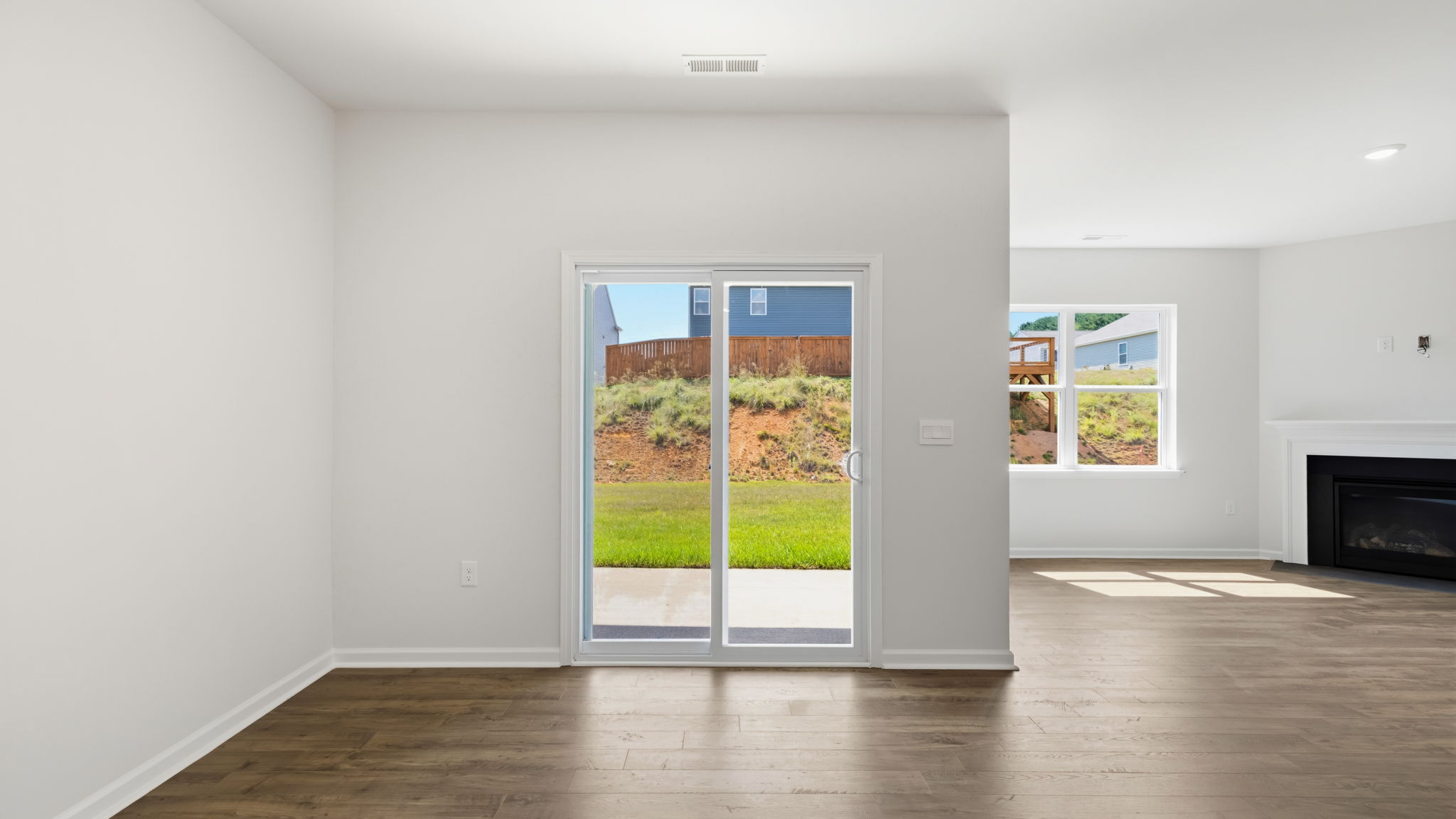 Open dining and living area with sliding glass door and gas fireplace