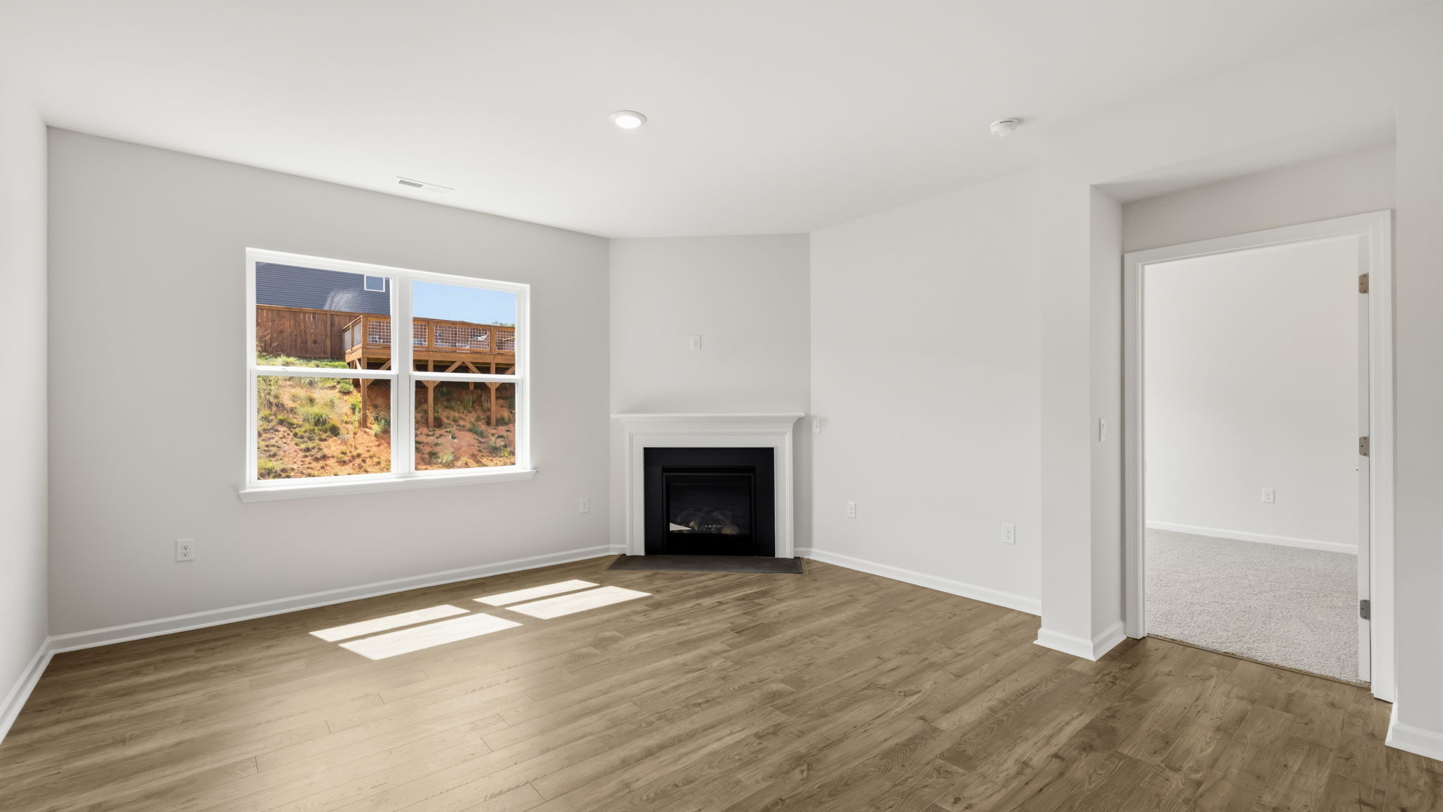 Open living area with large windows and gas fireplace