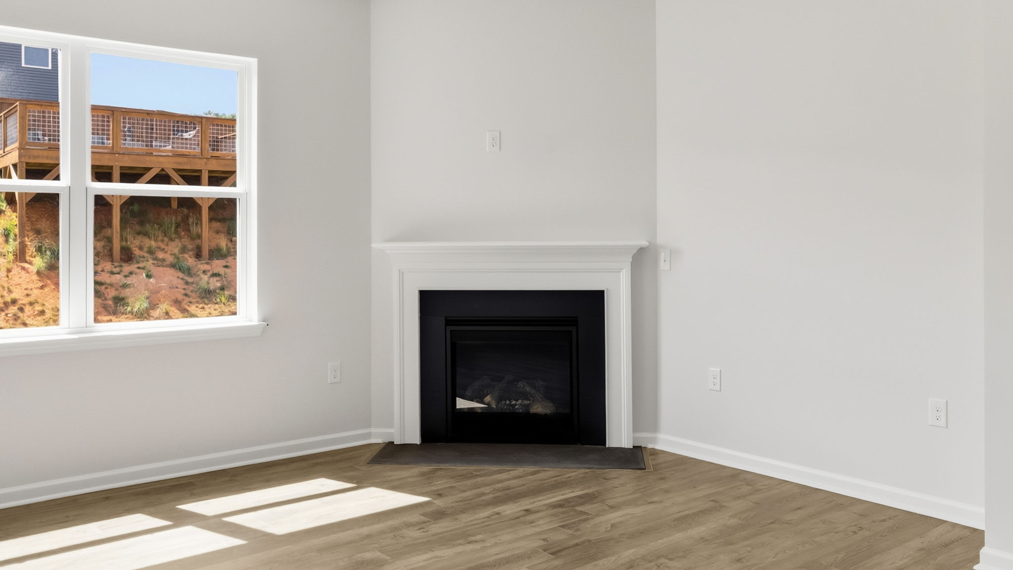 Open living area with large windows and gas fireplace