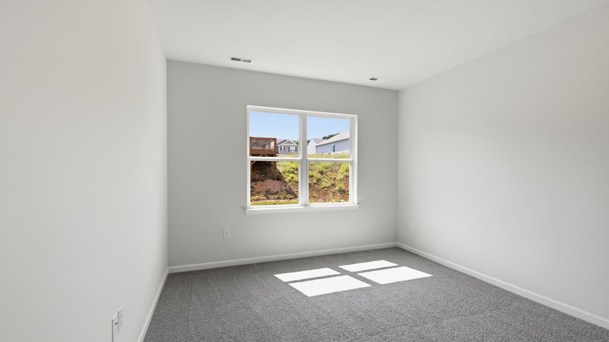 Carpeted bedroom with large window