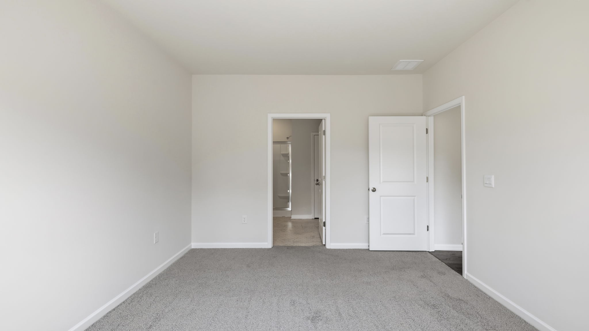 Carpeted bedroom with large window