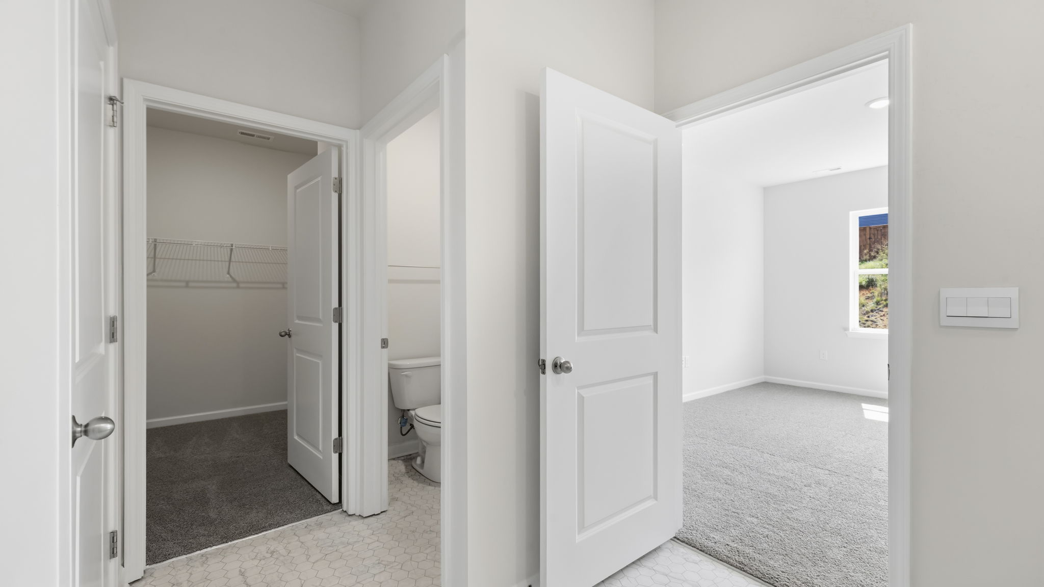 Primary bathroom with view of walk in closet