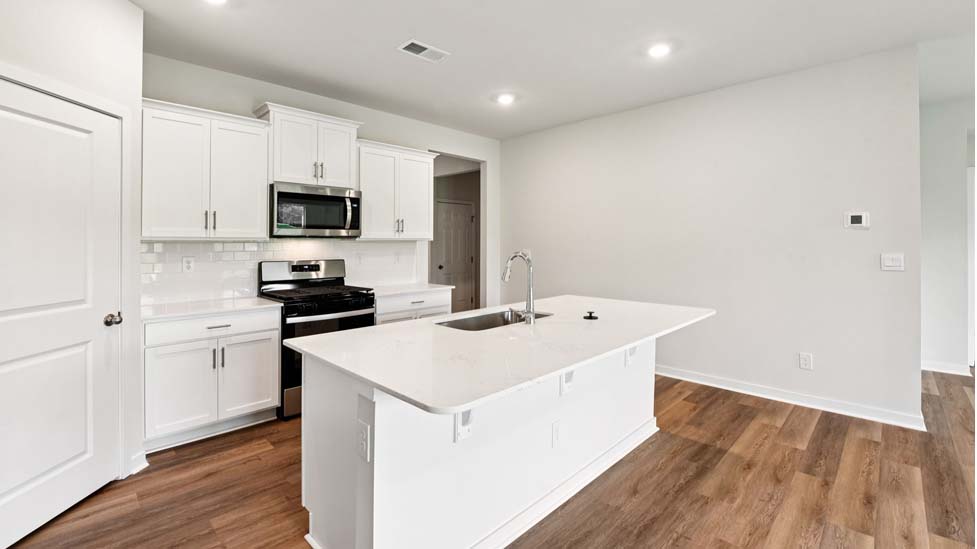 Open kitchen with stainless steel appliances and island