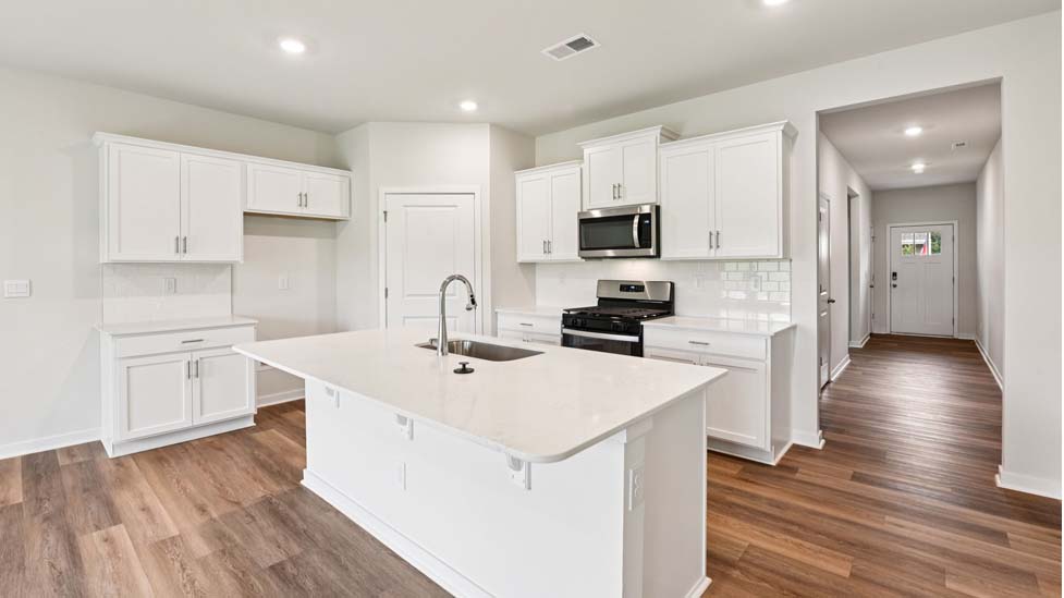 Open kitchen with stainless steel appliances and island