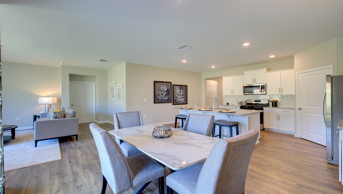 Open concept living space with gas fireplace and large windows