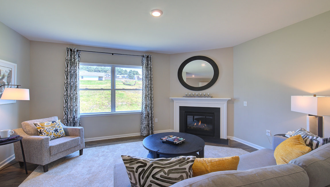 Open concept living space with gas fireplace and large windows