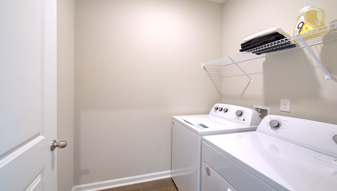 Laundry room with washer, dryer and shelving