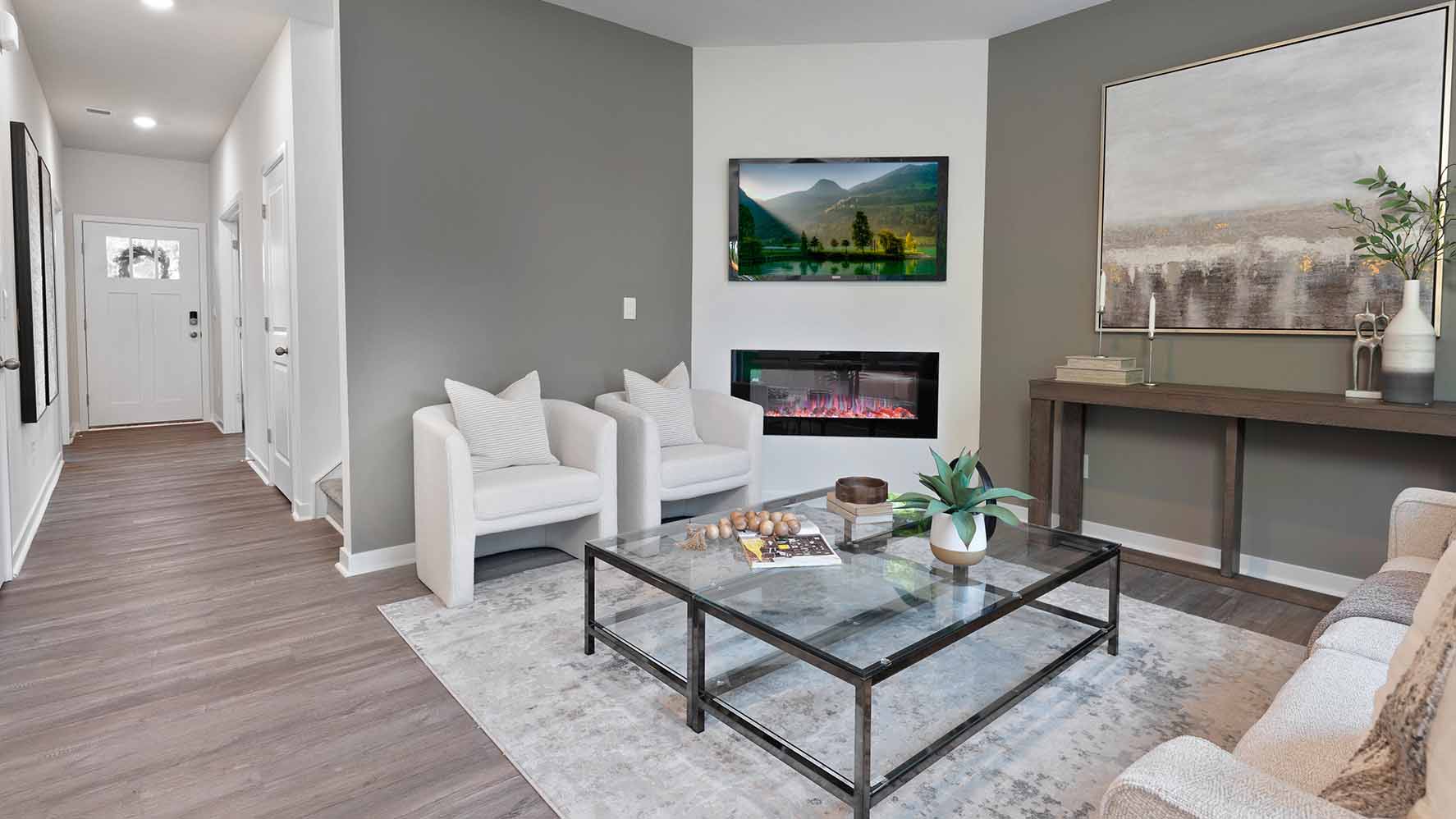 Living room with wood floors, fireplace and view of kitchen