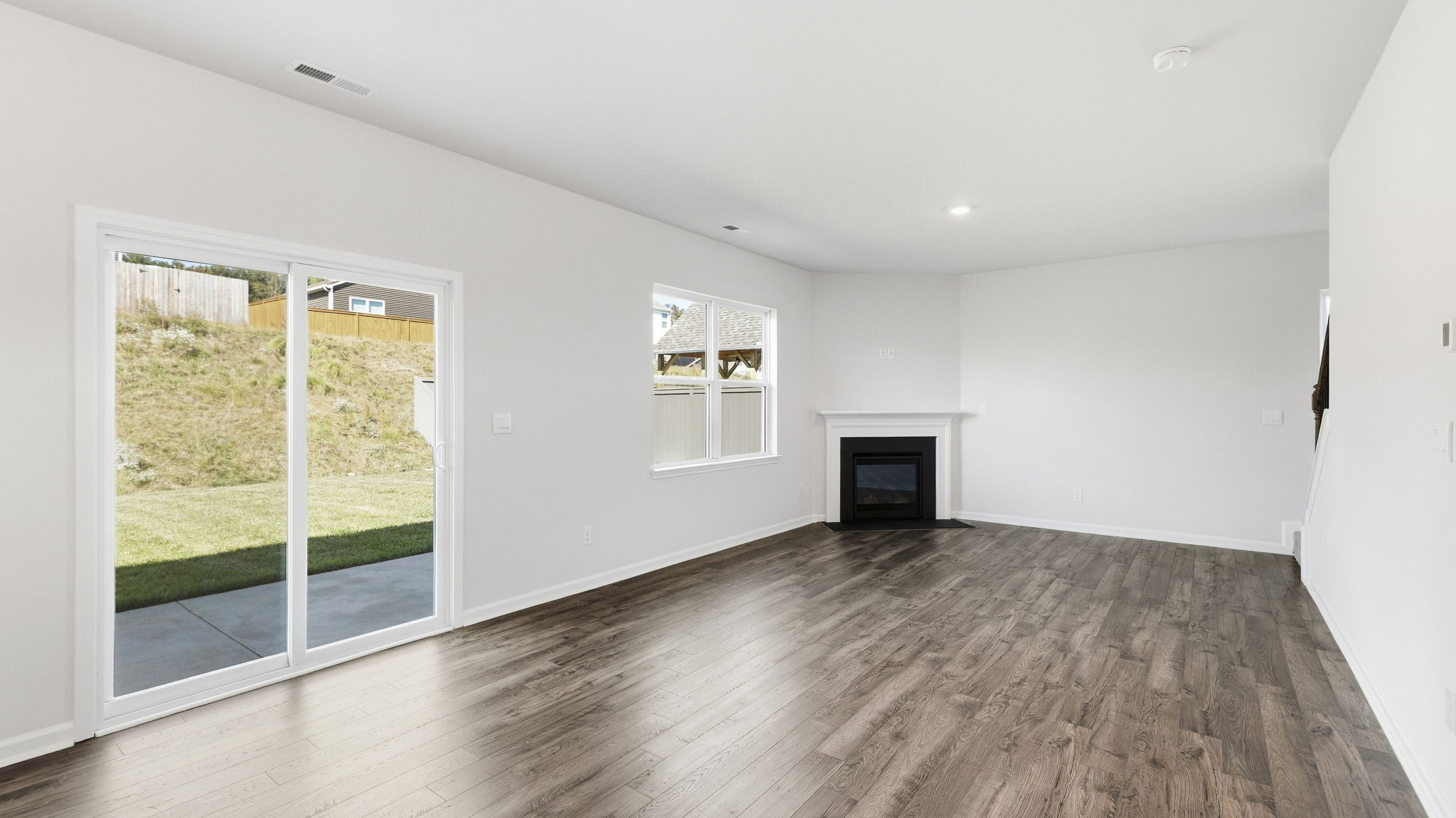 Open living room with sliding glass doors and gas fireplace