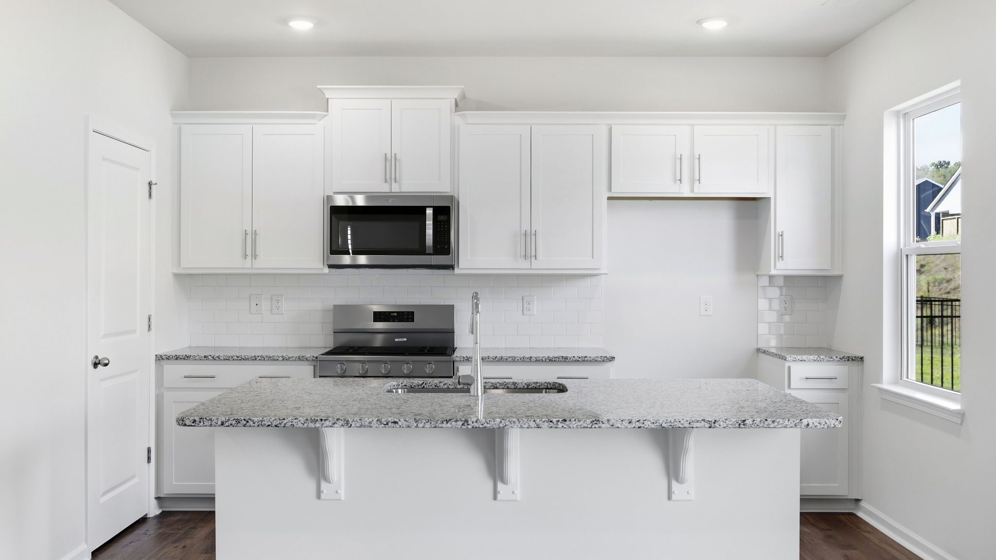 Open concept kitchen with large island and stainless steel appliances