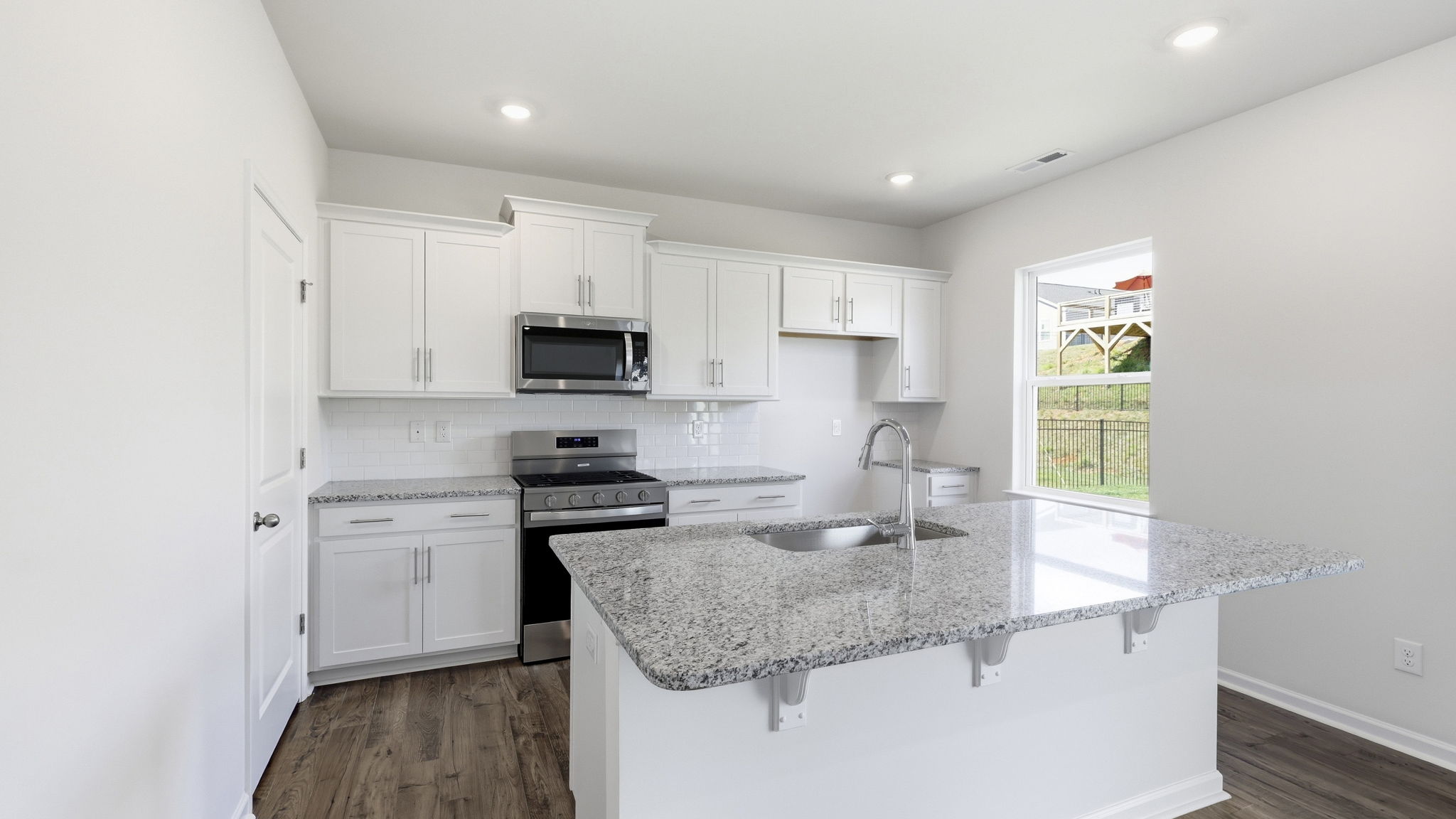 Open concept kitchen with large island and stainless steel appliances