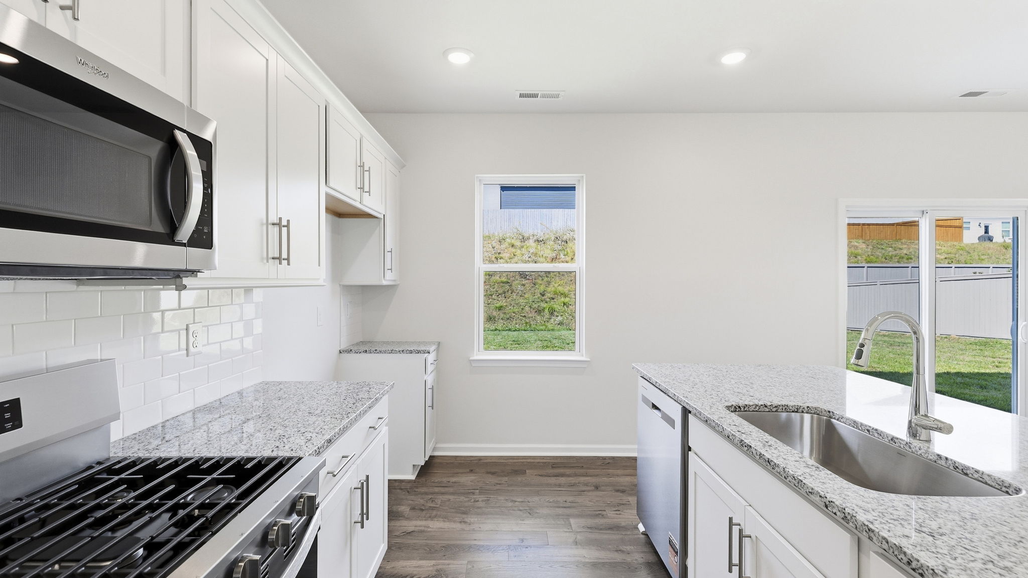Open concept kitchen with large island and stainless steel appliances
