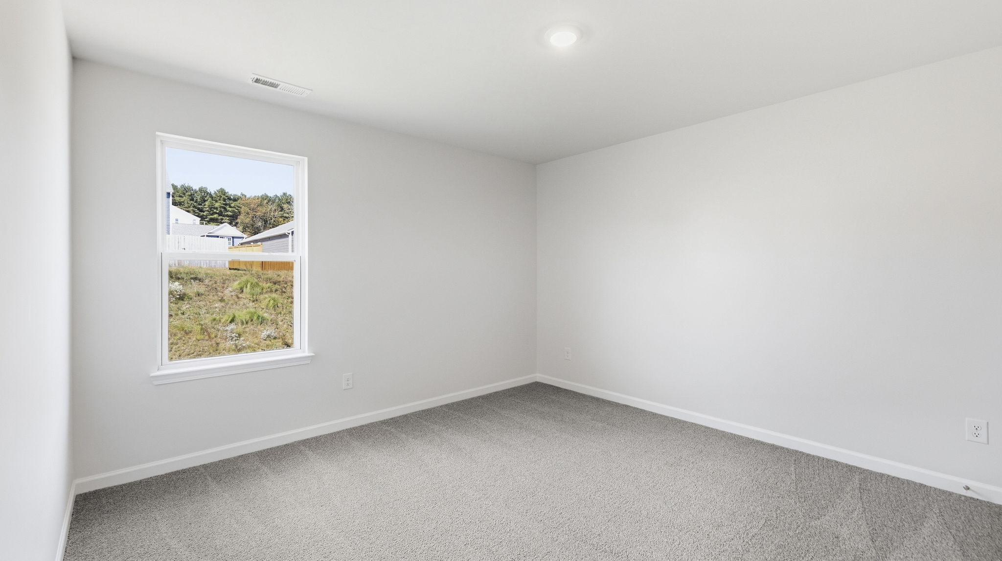 Carpeted bedroom with window