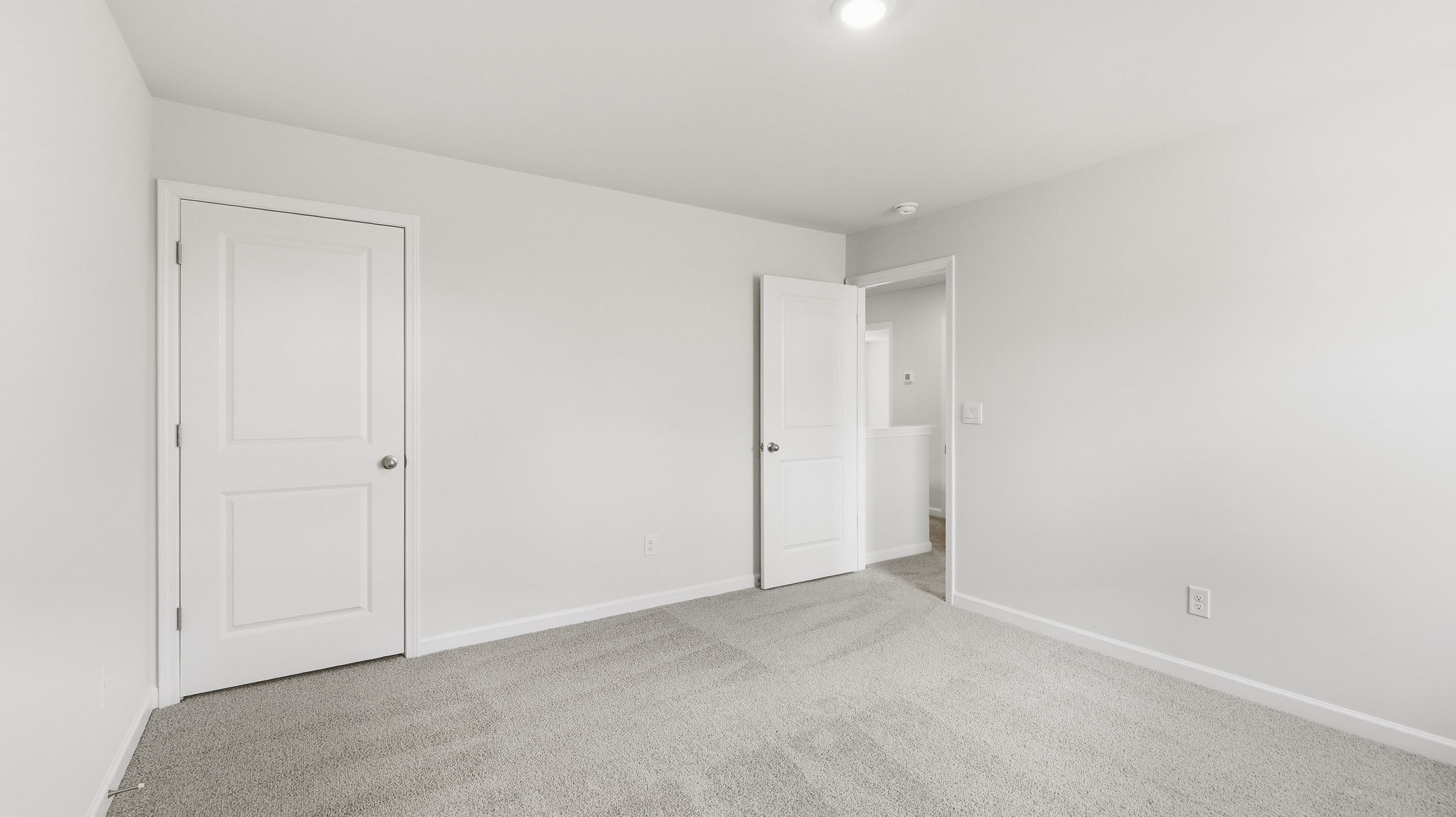 Carpeted bedroom with closet