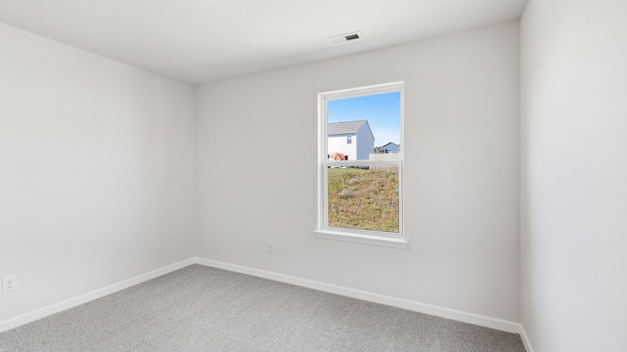 Carpeted bedroom with window