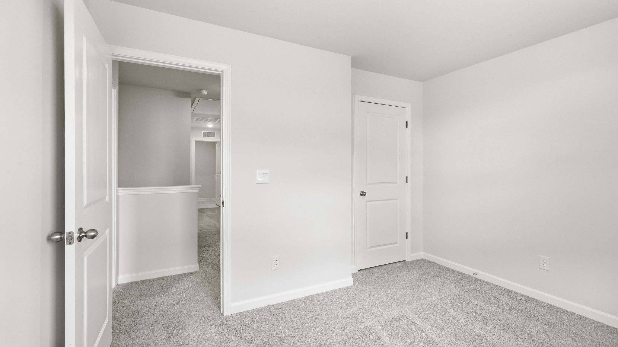 Carpeted bedroom with closet