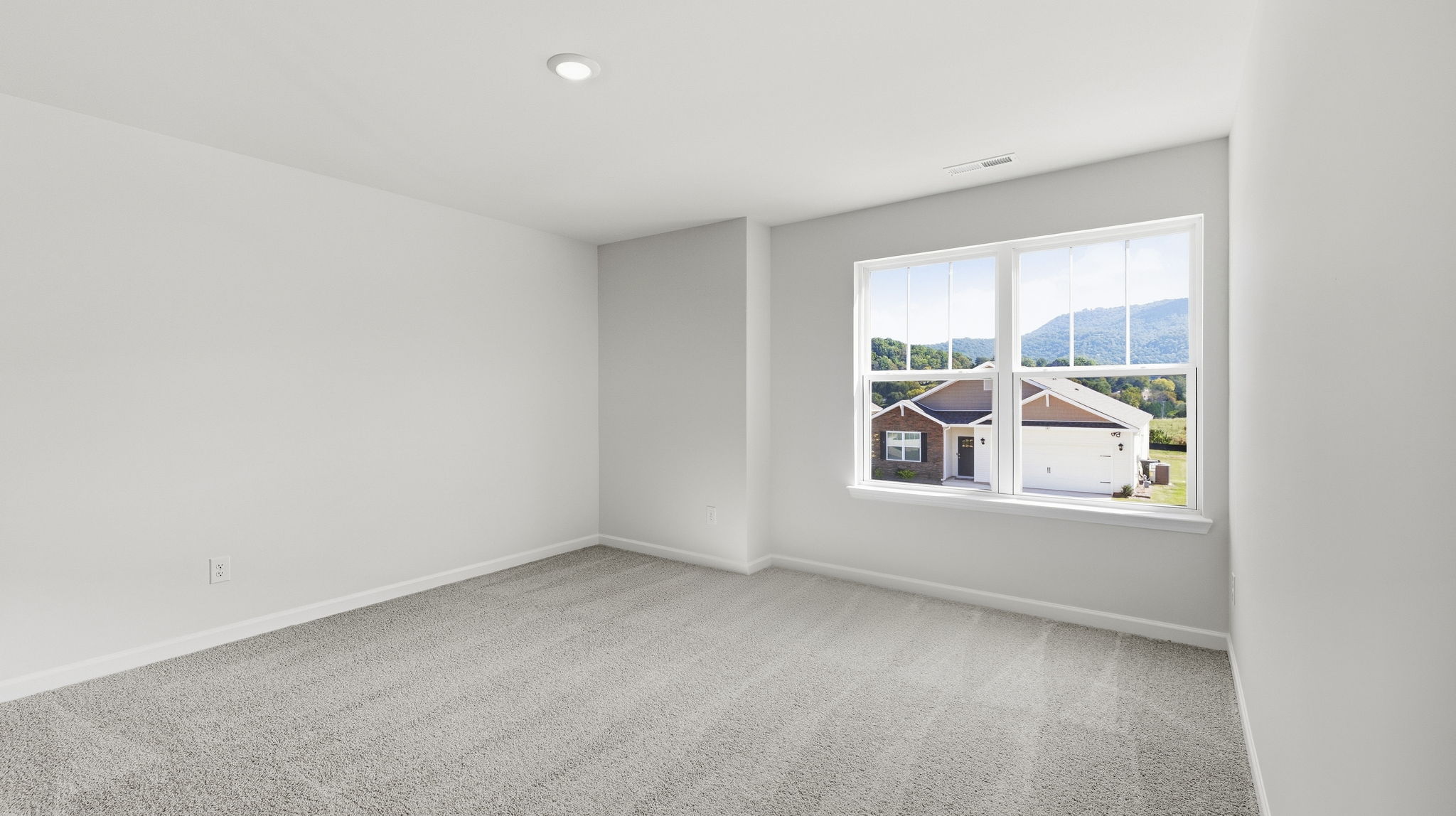 Carpeted bedroom with window