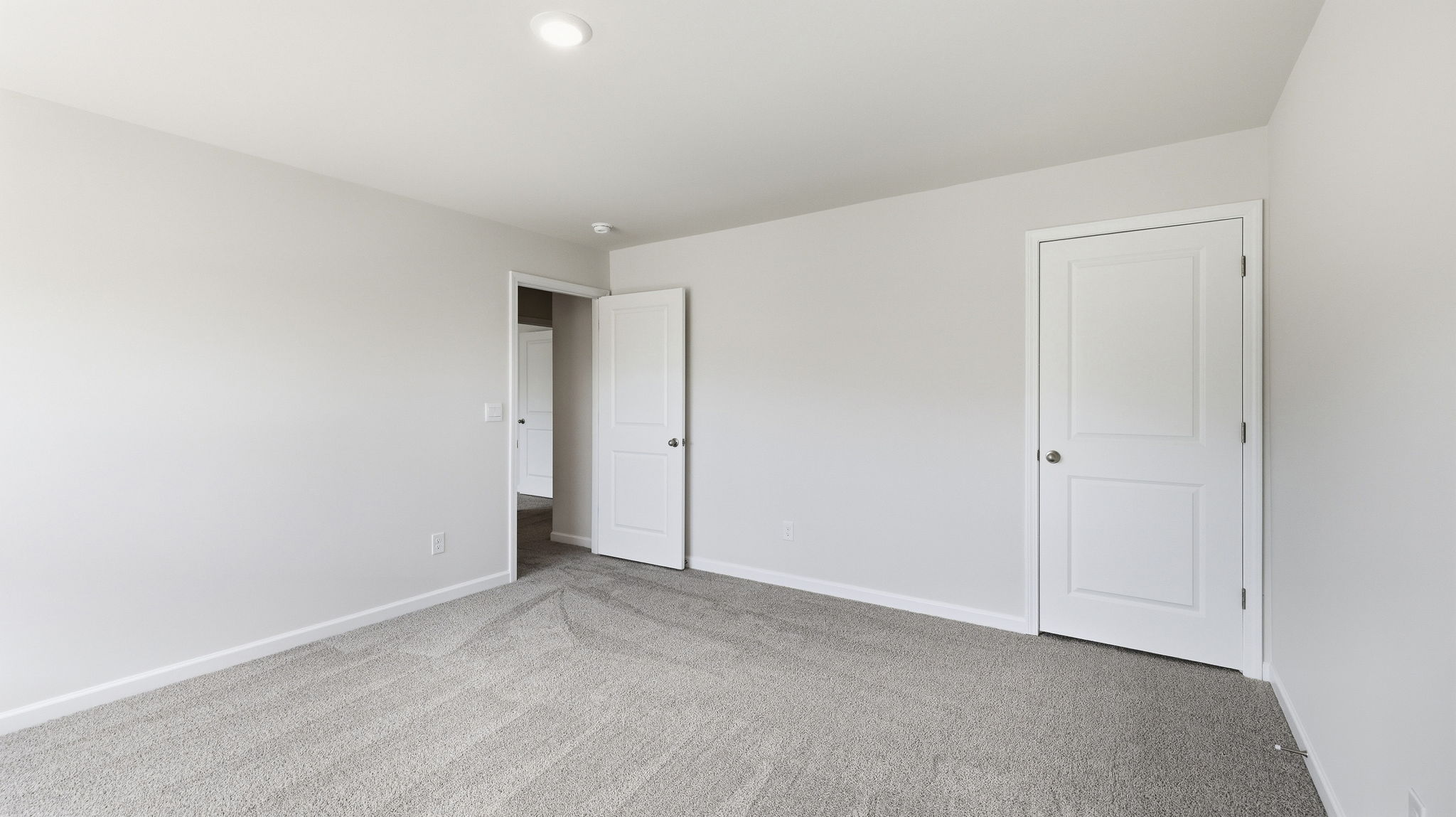 Carpeted bedroom with closet