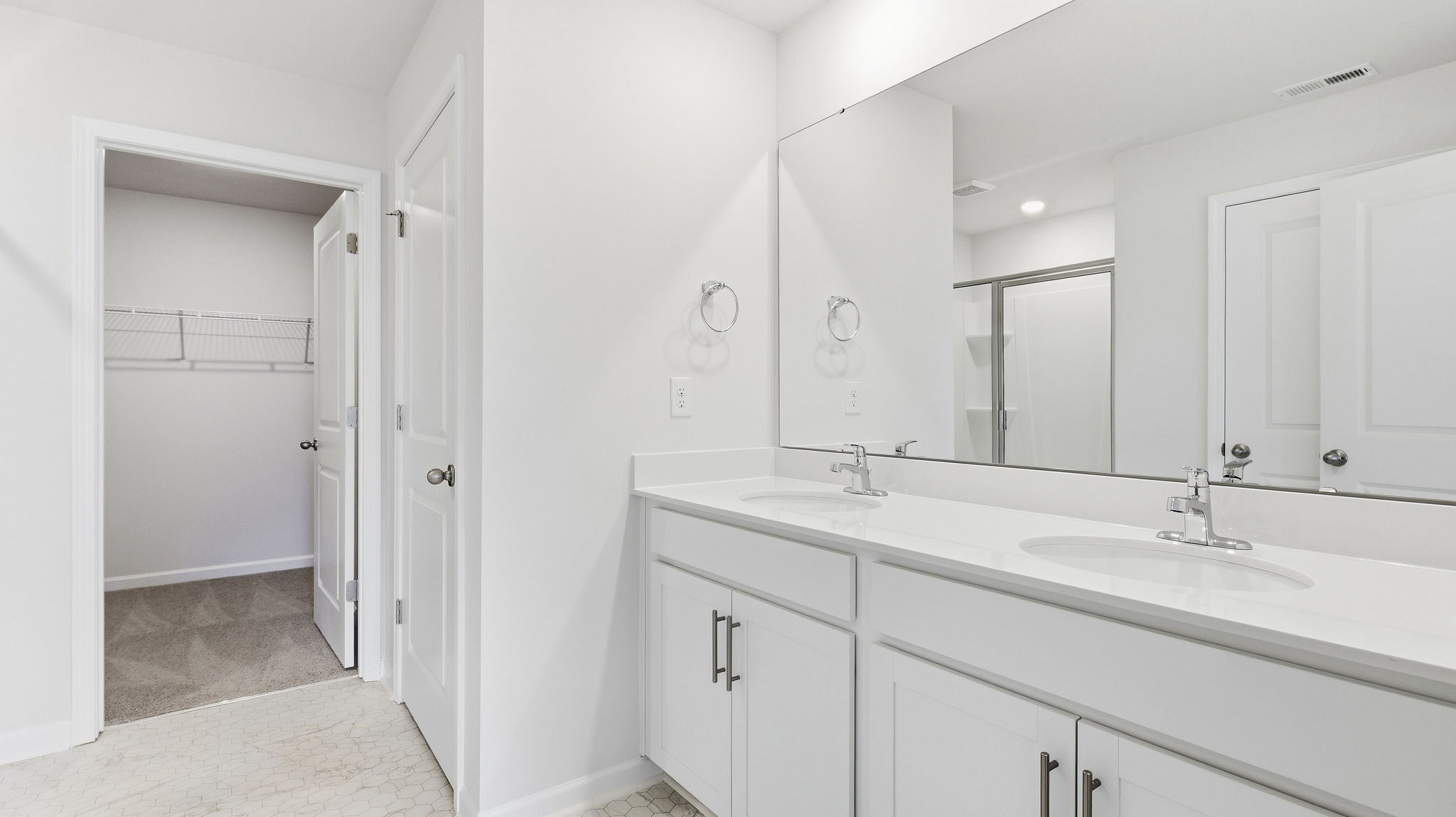 Primary bathroom with dual vanity and mirror