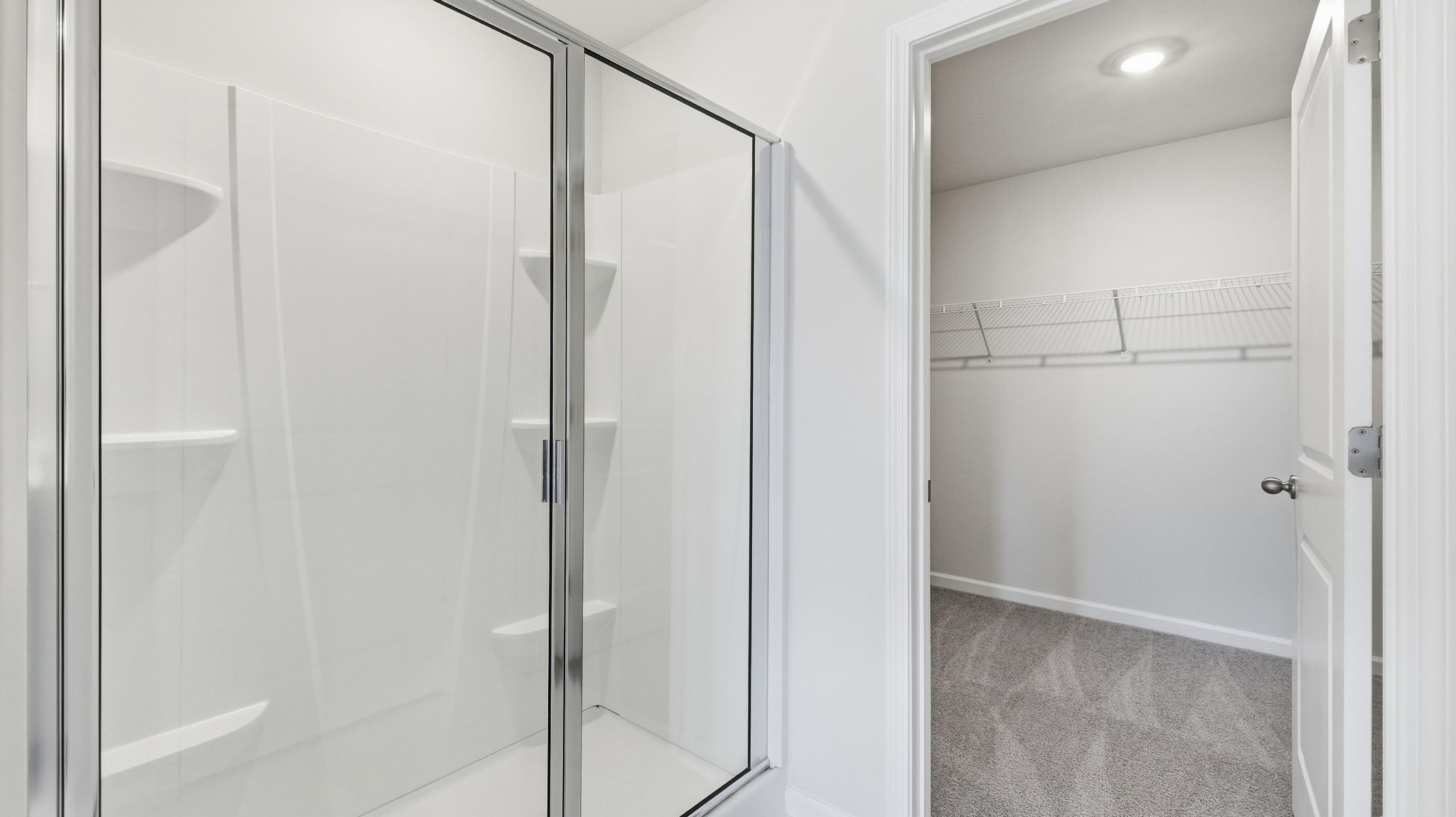 Primary bathroom with walk in shower and walk in cloest
