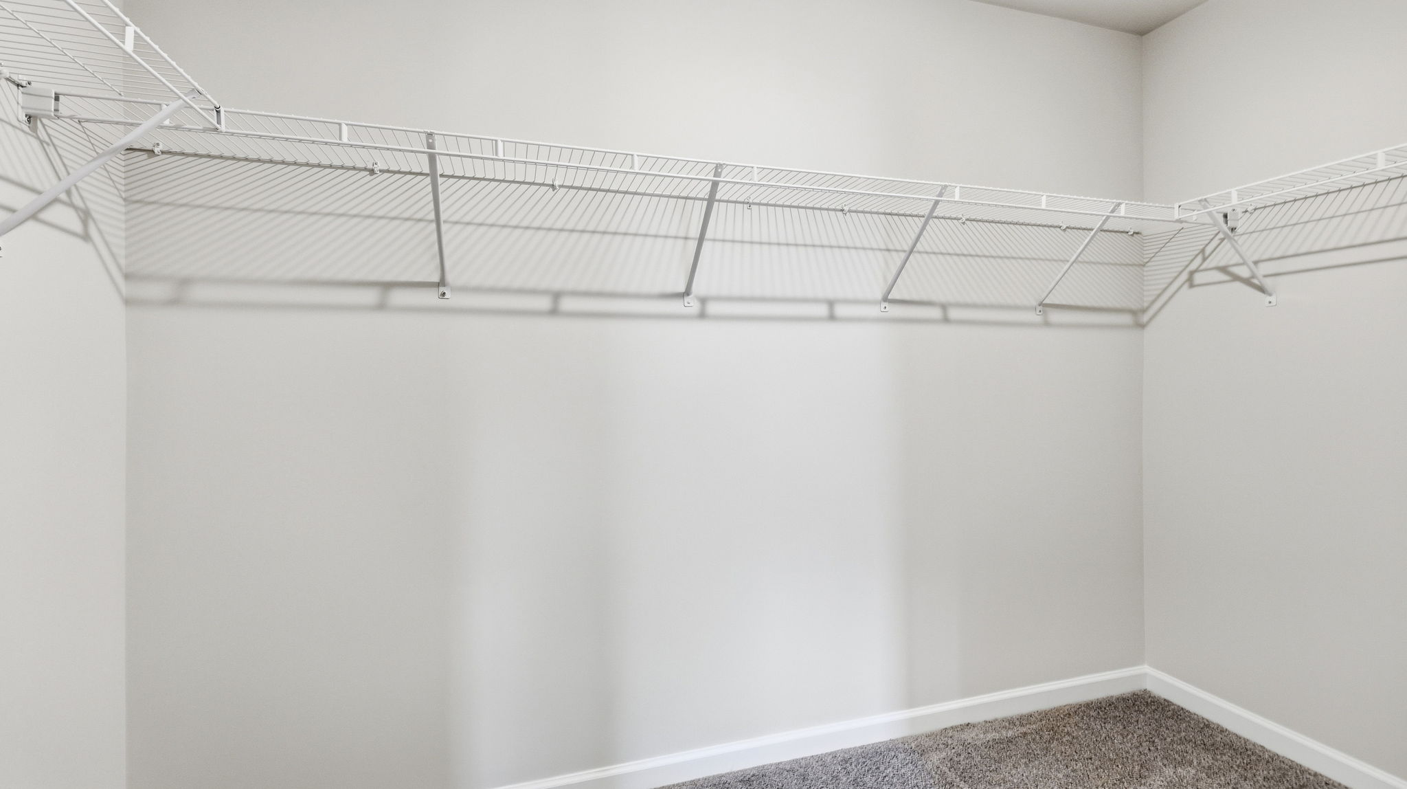 Primary walk in closet with shelving