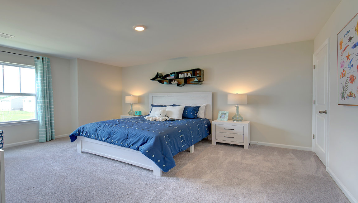 Carpeted bedroom with large windows