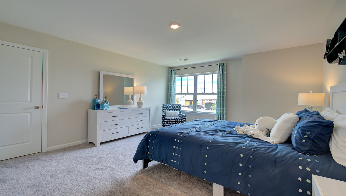 Carpeted bedroom with large windows