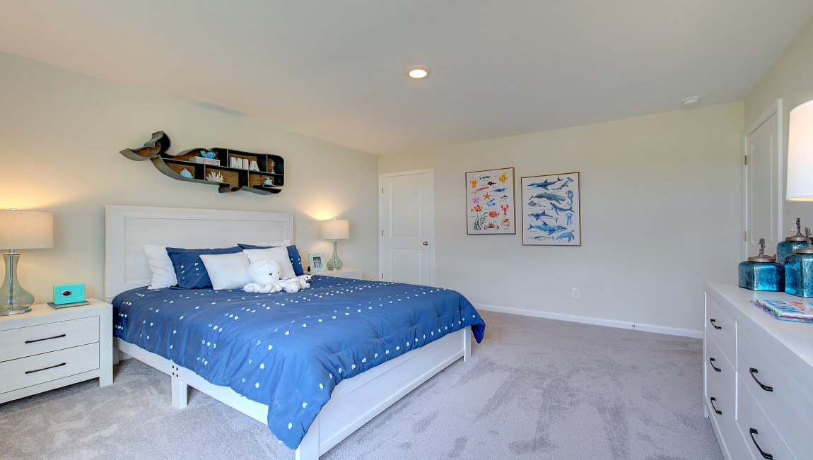 Carpeted bedroom with large windows