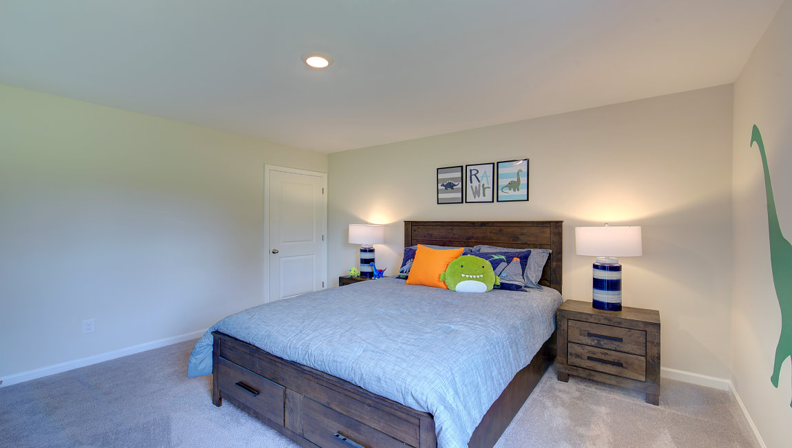 Carpeted bedroom with large windows