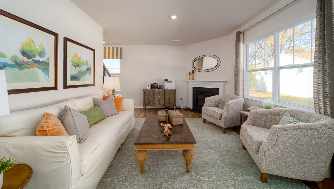 living room with wood floors, electric fireplace and large window