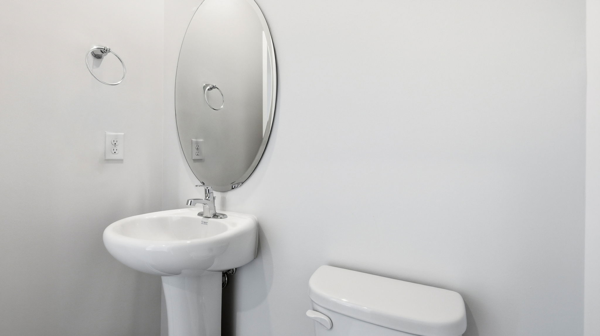Half bathroom with single sink and mirror