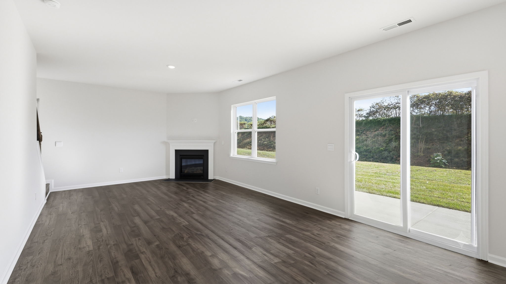 Open living area with large windows and gas fireplace